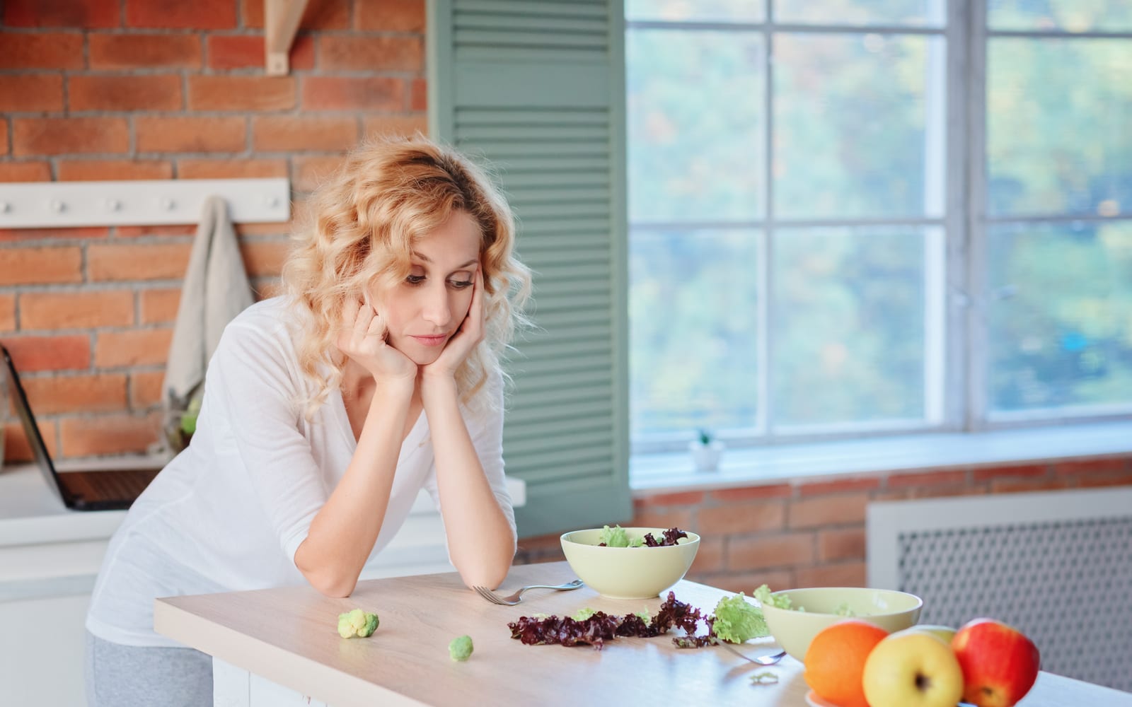 Depressed woman at kitchen table